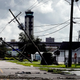 A woman looks over damage to a neighborhood caused by Hurricane Ida on Aug. 30, 2021 in Kenner, Louisiana.